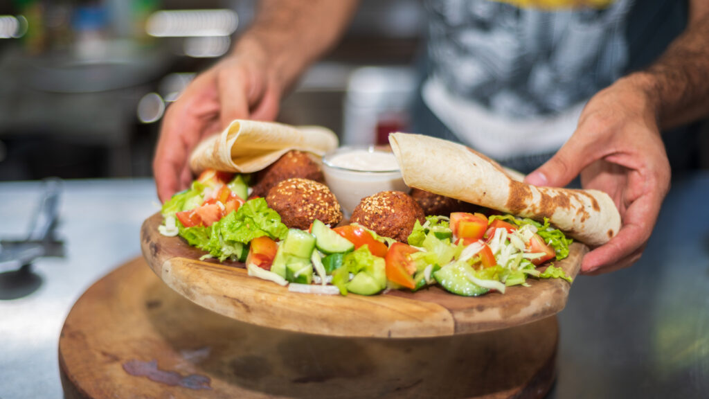 presenting the middle eastern lebanese dish falafel on a wooden plate  scaled