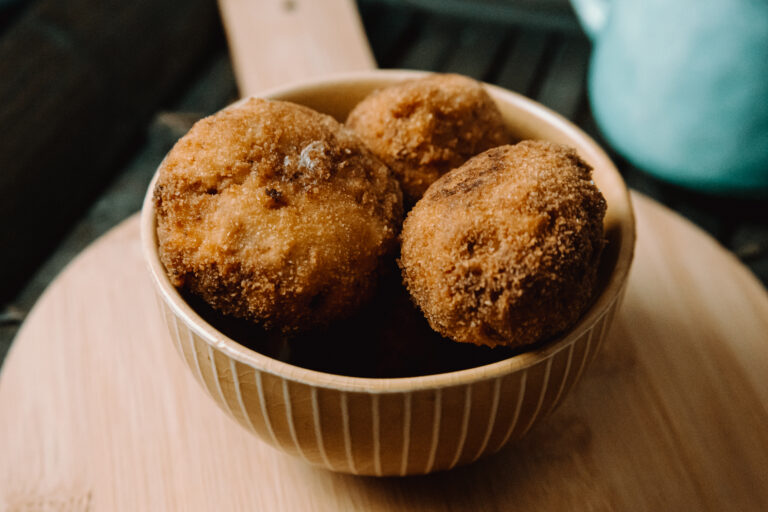 some fried meatballs over a wooden table on the kitchen